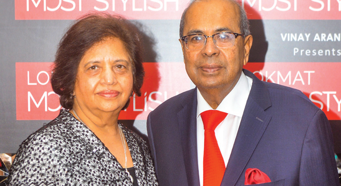Prakash Hinduja with wife Kamal Hinduja both looking stunning. Prakash wearing red tie and glasses.